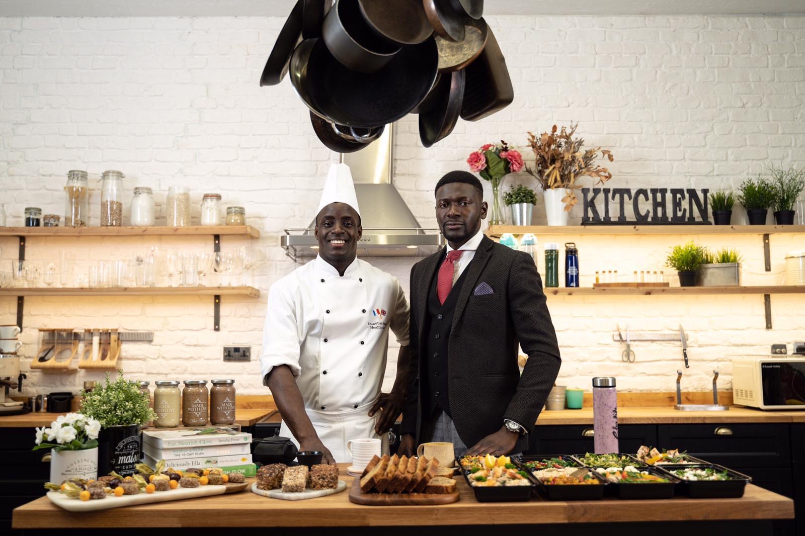 Private chef and event manager in a professional kitchen with prepared dishes